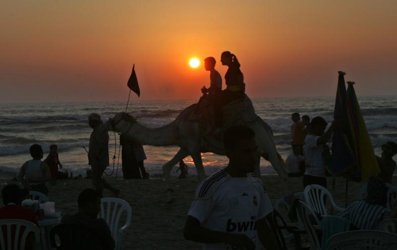 Palestinians enjoy a beach in Gaza