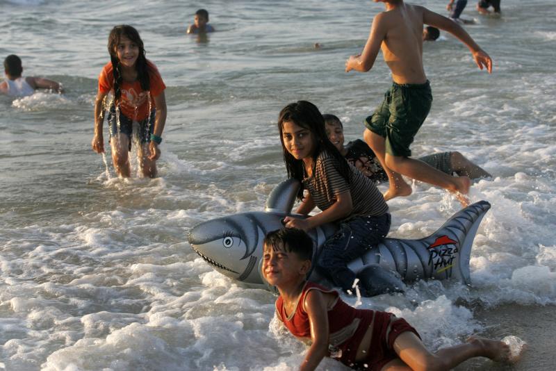 Palestinians enjoy a beach in Gaza